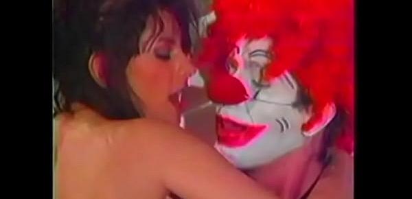  Sexy brunette with a fantastic ass loves doggy style fucking from a clown